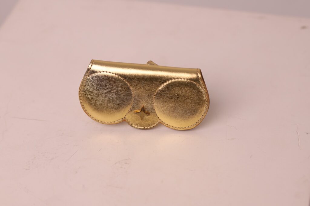 Gold leather sunglasses cover by Kairos with signature star detail
